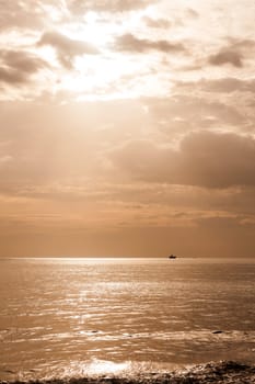 sunbeam at horizon on sea in morning with cloud