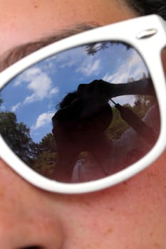 young woman with sunglasses close up