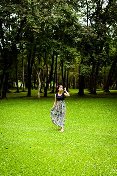 Portrait woman asian girl with tree background  in the garden