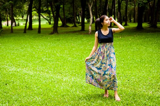 Portrait woman asian girl with tree background  in the garden