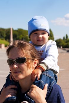 Mom and baby are walking on the shoulders