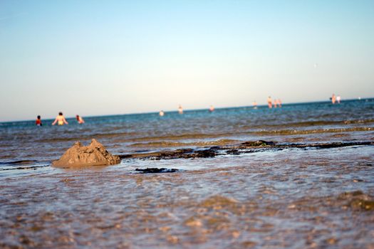 broken sandcastle at the beach