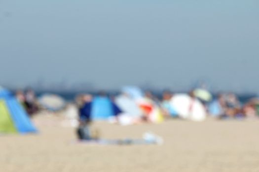 blur background : people relaxing on the beach