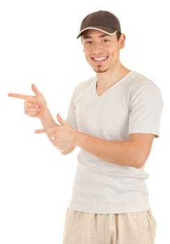 Smiling young man in a hat is pointing sideways. Isolated on white.