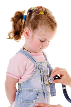 Healthy small girl is examed by stethoscope isolated on white background. The girl is looking down.