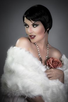 sensuous short haired brunette woman, bare shoulders with white fur, flirty and beautiful, 20s hollywood style