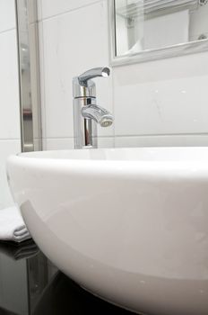 Elegance white washstand and faucet. Gocus on faucet.