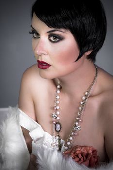 sensuous short haired brunette woman, bare shoulders with white fur, flirty, beautiful, sweet, 20s old hollywood