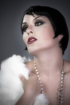 gourgeos brunette flapper wearing pearls necklace and fur
