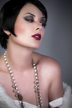 gourgeos female brunette flapper wearing pearls necklace and fur