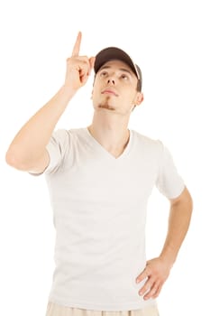 Casual young man in a hat is pointing and looking up. Isolated on white.