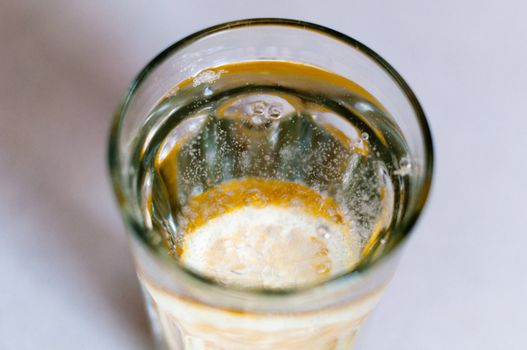 slice of lemon drops in a glass of mineral water