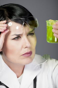 brunette female doctor checking laboratory samples with protective glasses, career women, PHD