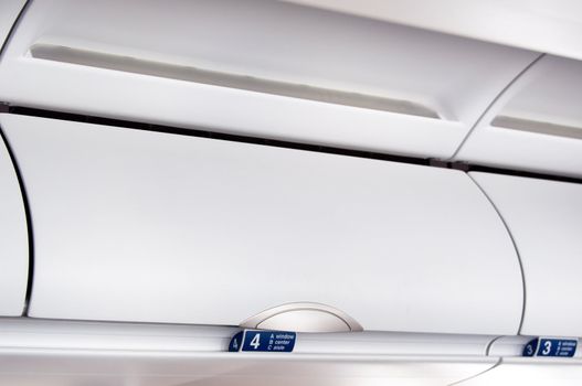 Overhead compartment - detail shot of an airplane cabin interior