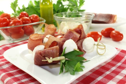 skewers with mozzarella, tomato, basil and ham