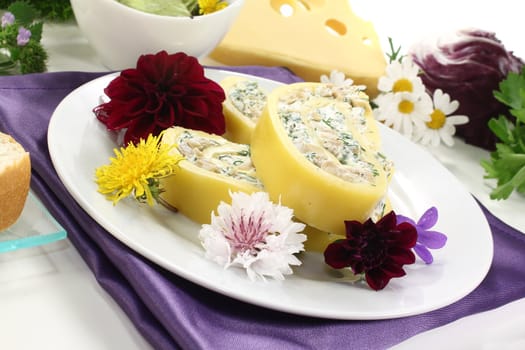 delicious stuffed cheese rolls with cream cheese and herbs on a light background