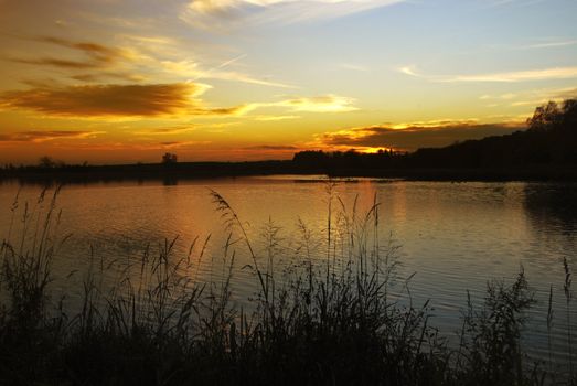 Beautiful colorful sunset over the lake in summer