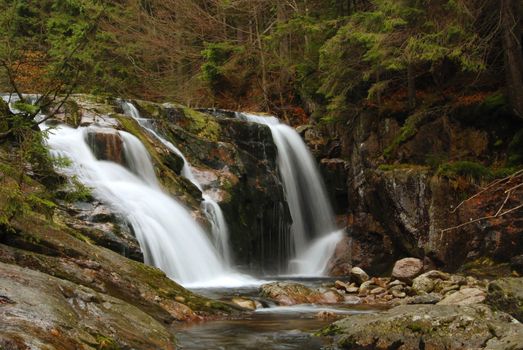 Waterfall in the autumn forest with a long exposure