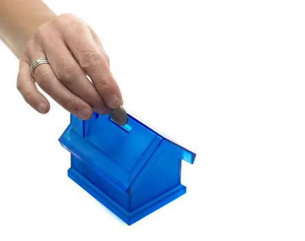 female hand putting money in the house