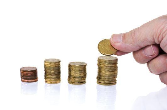 man putting euro coin on stack money