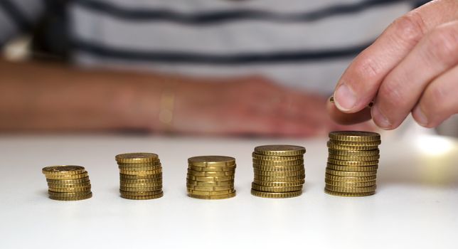 euro coins with human hand