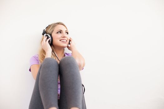 young beautiful woman listen music with headphones isolated