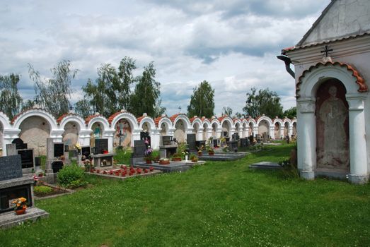 Old Czech church in the country with a graveyard