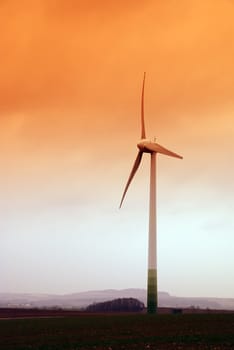 Wind turbine propeller and a sunset sky