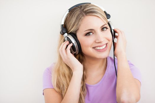 young beautiful woman listen music with headphones isolated