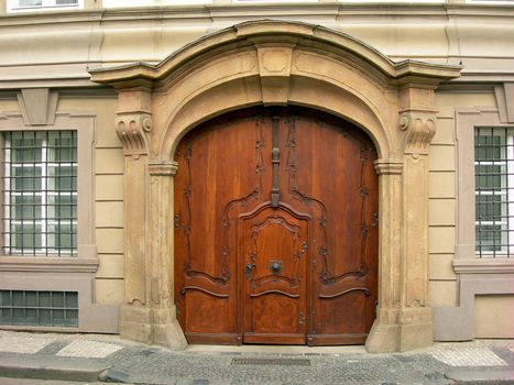           Old wooden portal of  in Prague with two pillars on a side