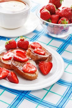 French toasts with powdered sugar and a strawberry