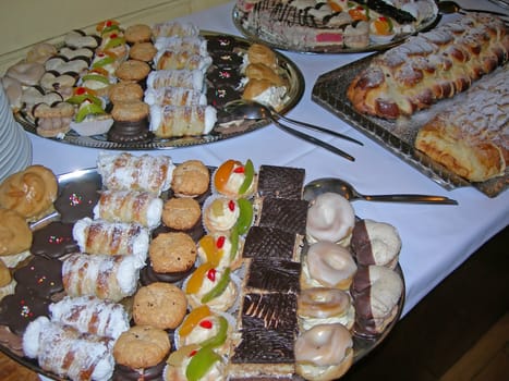           Variety of tasty desserts with cream and chocolate on a dish