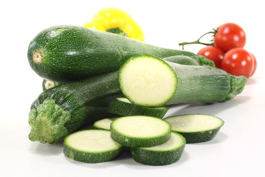 Zucchini with tomatoes and peppers on a light background