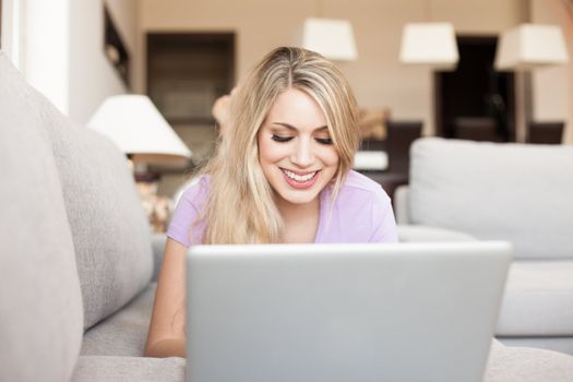 young beautiful woman using a laptop computer at home