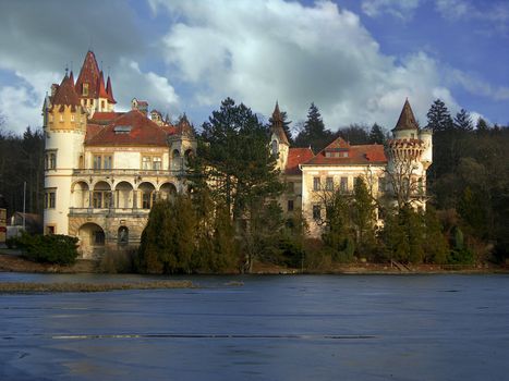                     Beautiful romantic castle with river and forest in the Czech Republic