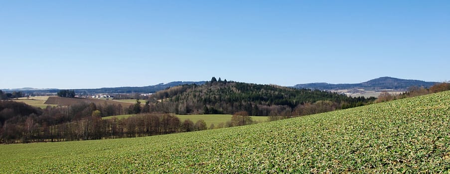 Beautiful landscape shot of Czech country with hills and blue sky