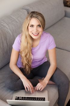 young beautiful woman using a laptop computer at home