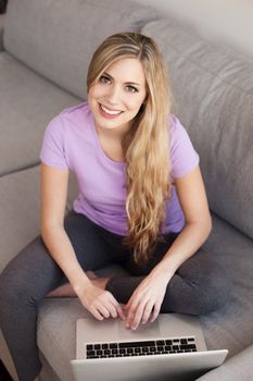 young beautiful woman using a laptop computer at home