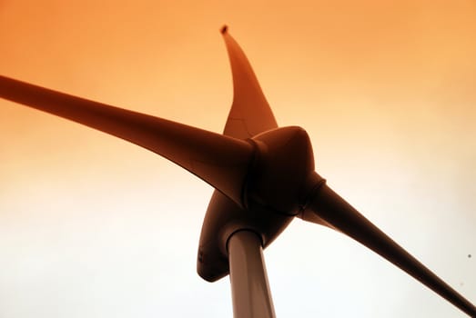 Wind turbine propeller and a sunset sky