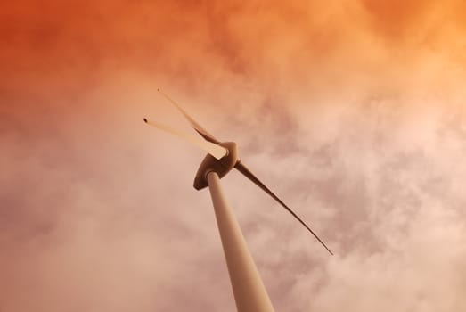 Wind turbine propeller and a sunset sky