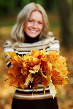 woman portret in autumn leaf close up