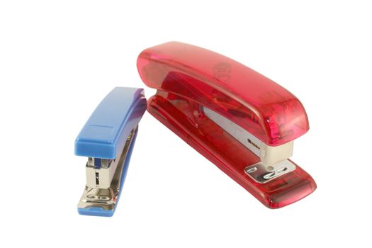 Blue and pink staplers over white