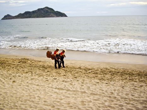 MAZATLAN, SINALOA/MEXICO � FEBRUARY 7: Two Mariachi musicians stroll on beach at sunset carrying their instruments heading for the next tourist performance shown on February 7, 2010 in Mazatlan