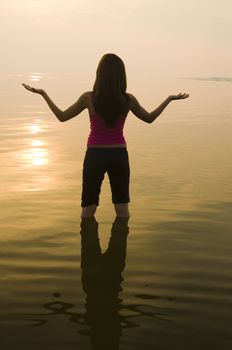 silhouette of an asian girl performing yoga 