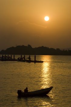 silhouette of a man fishing