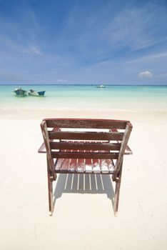 a beach with a lonely chair at perhentian island,malaysia
