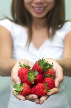 asian girl holding strawberry