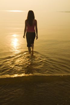 silhouette asian girl walking on a beach