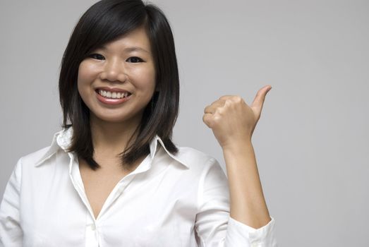 asian women smiling and giving thumbs up