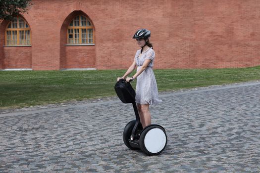 Young woman moving on self-balancing electric vehicle
